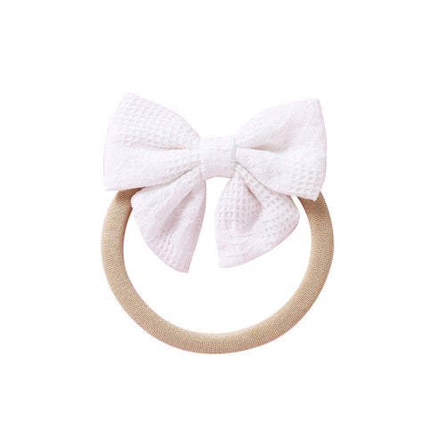 White knit textured baby headband with bow detail — Baby Small Waffle Bow Headband on white background