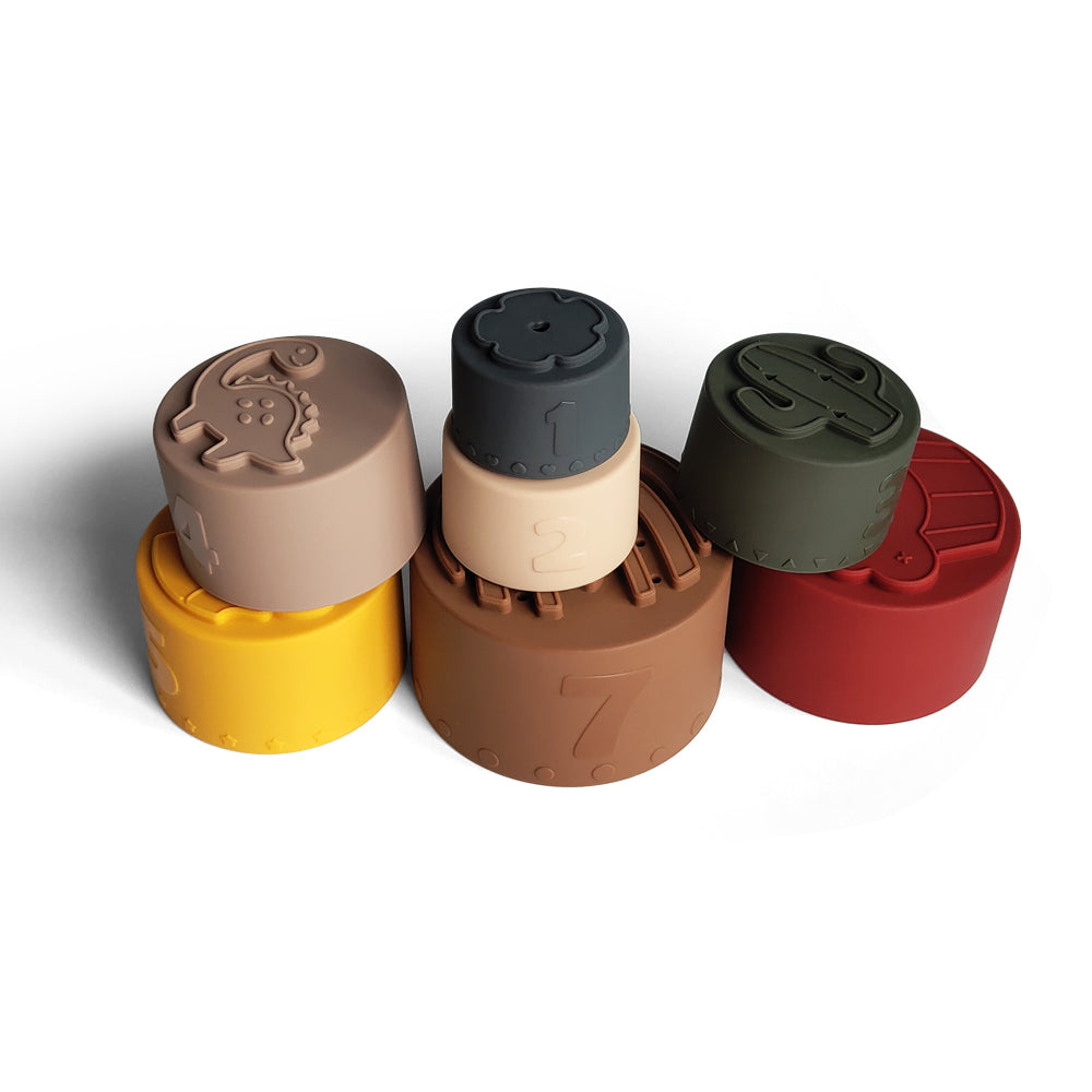 Silicone Baby Stacking Cups Bath & Beach in Earthy — baby hat styled flat lay with nursery accessories