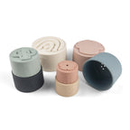 Silicone Baby Stacking Cups Bath & Beach in Pastel — baby hat styled flat lay with nursery accessories