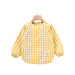 a yellow and white checkered shirt hanging on a wooden hanger