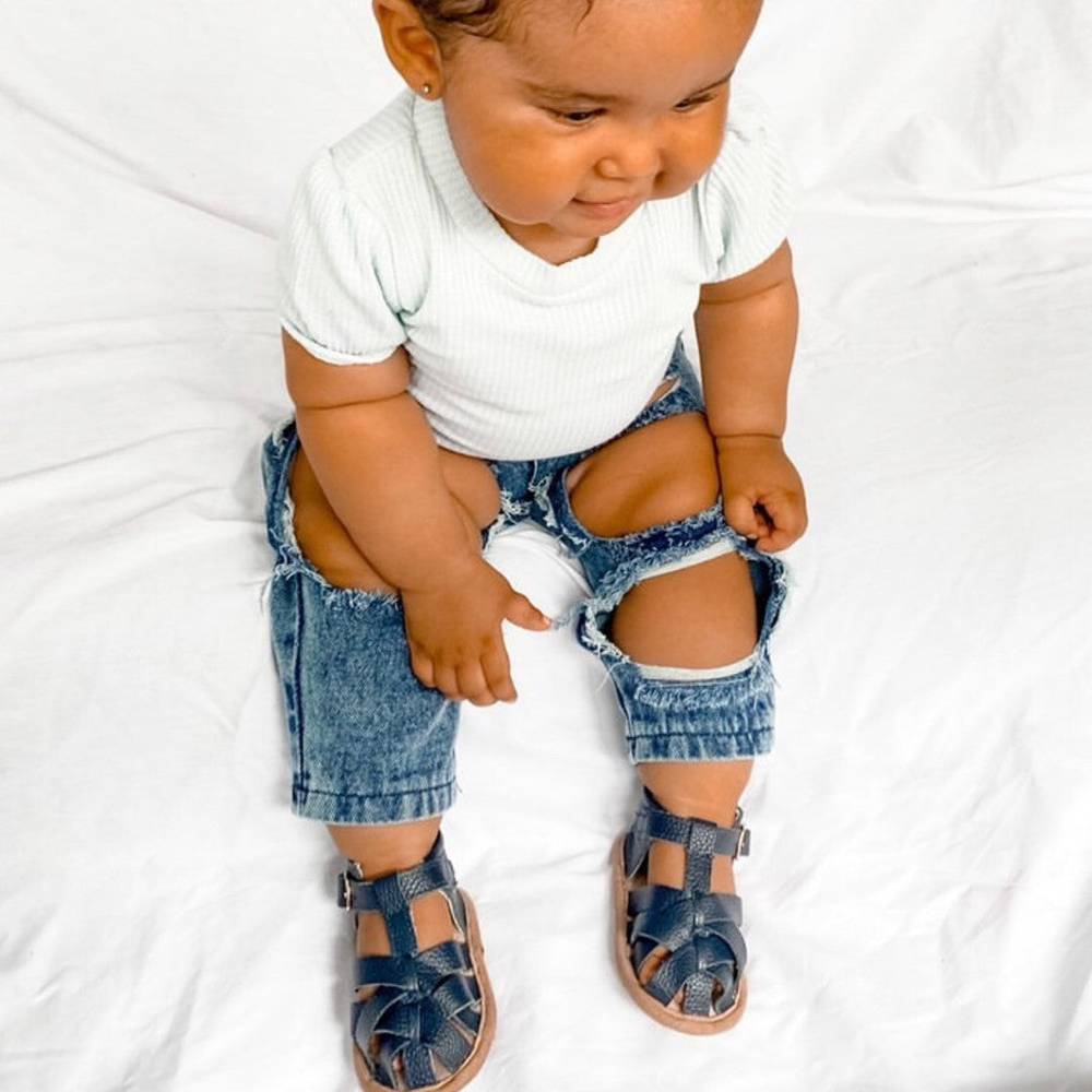 Zodiac Blue Leather Baby Sandal — baby sandals styled flat lay with nursery accessories