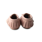 Piglet Baby Fringed Moccasin Shoe — baby shoes styled flat lay with nursery accessories