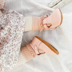 Wisp Pink Leather Baby T Bar Shoe — baby shoes styled flat lay with nursery accessories