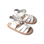 Baby feet in baby sandals on soft surface — Snow White Weave Leather Baby Sandal