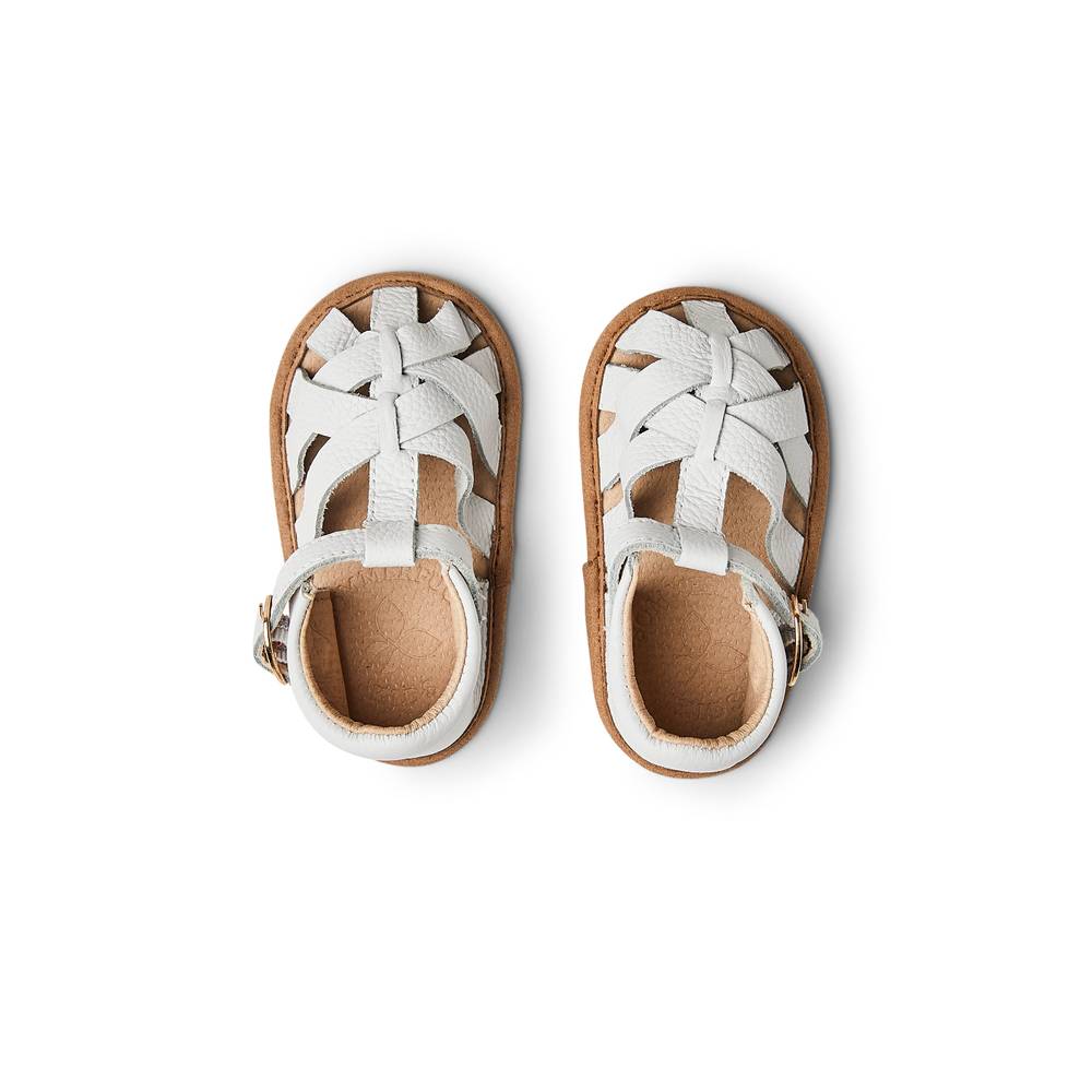 Baby feet in baby sandals on soft surface — White Leather Baby Sandal