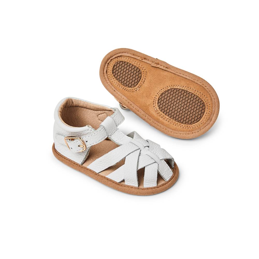 Baby feet in baby sandals on soft surface — White Leather Baby Sandal