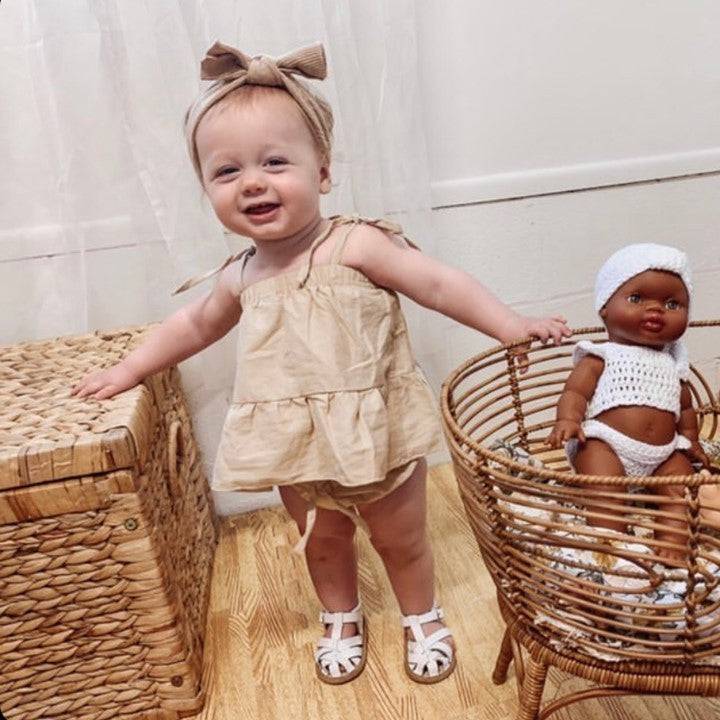 White Leather Baby Sandal — baby sandals styled flat lay with nursery accessories