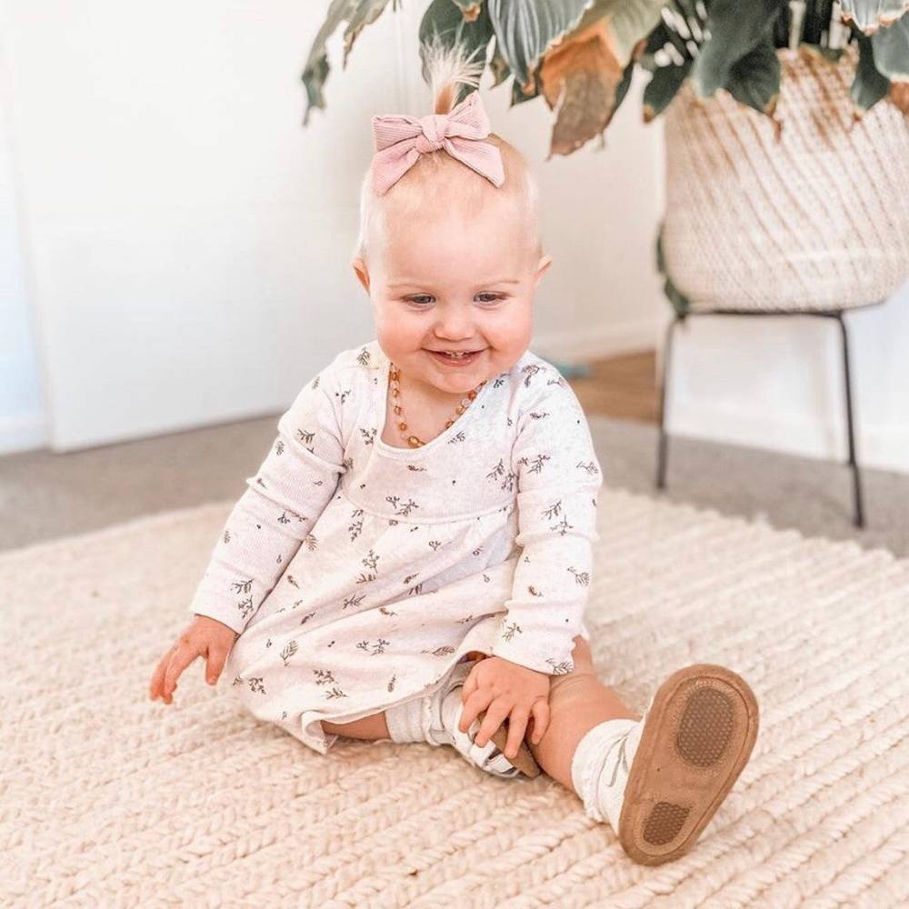 White Leather Baby Sandal — baby sandals styled flat lay with nursery accessories