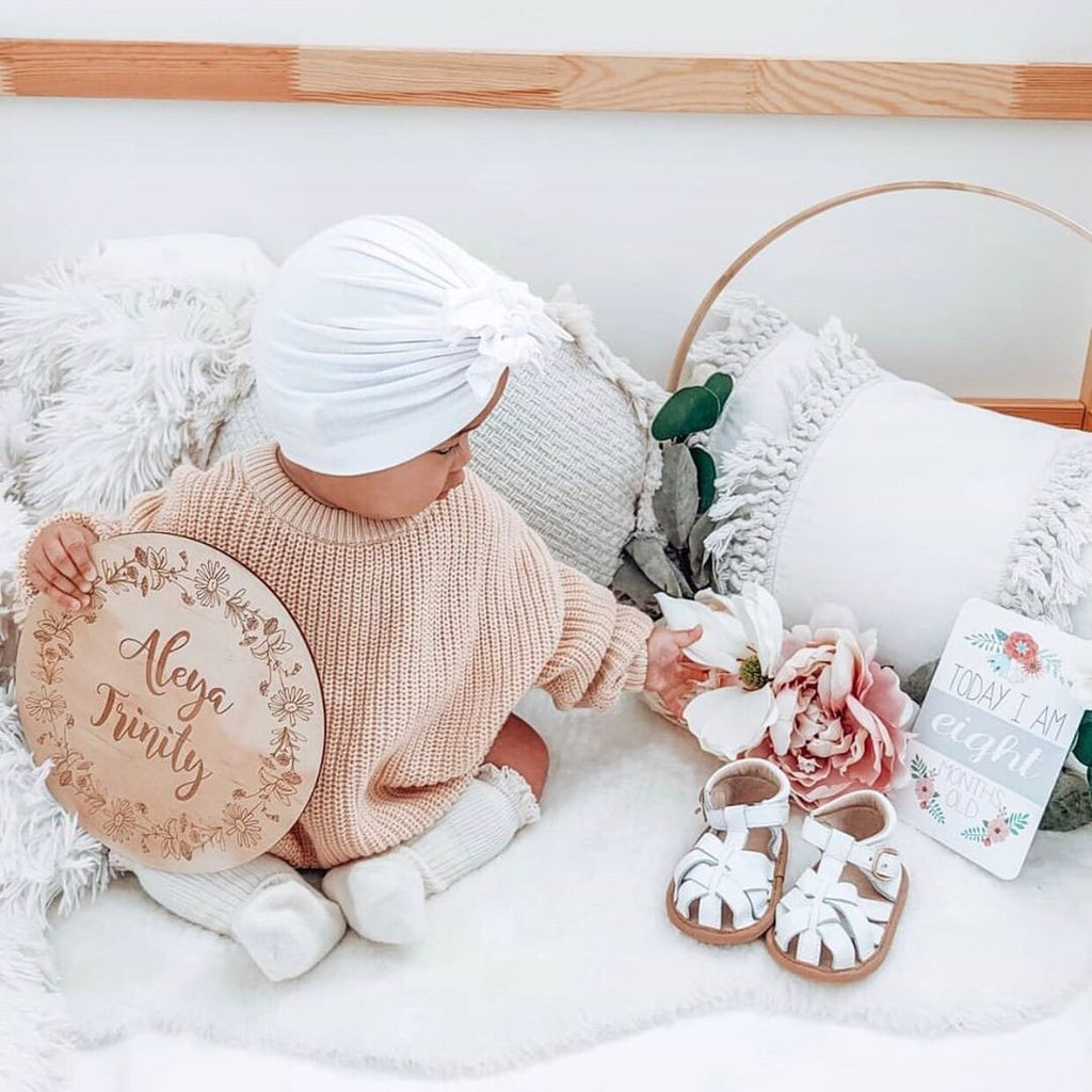 White Leather Baby Sandal — baby sandals styled flat lay with nursery accessories