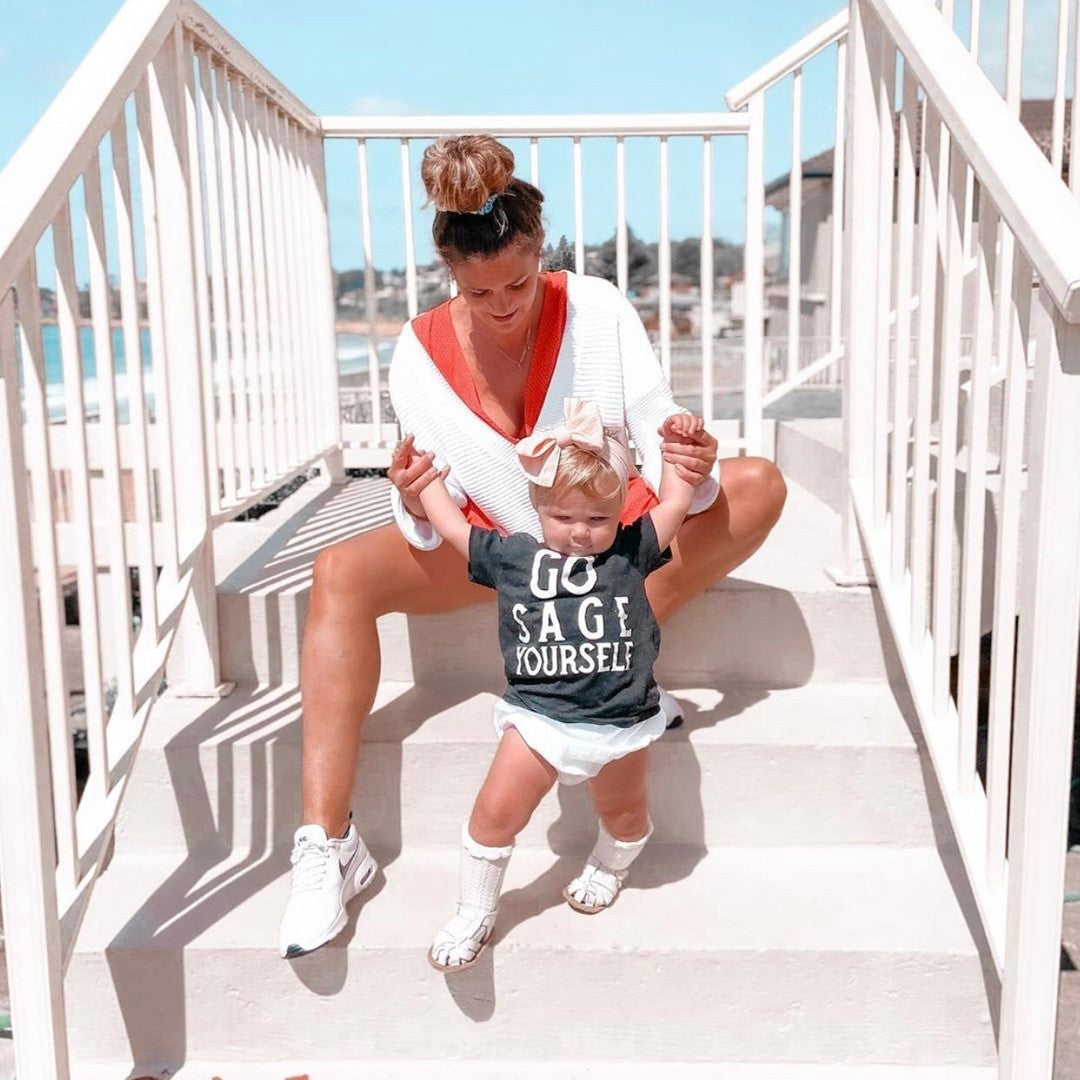 White Leather Baby Sandal — baby sandals styled flat lay with nursery accessories