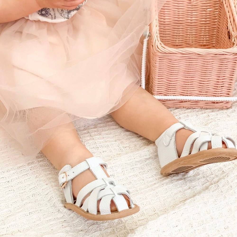 White Leather Baby Sandal — baby sandals styled flat lay with nursery accessories