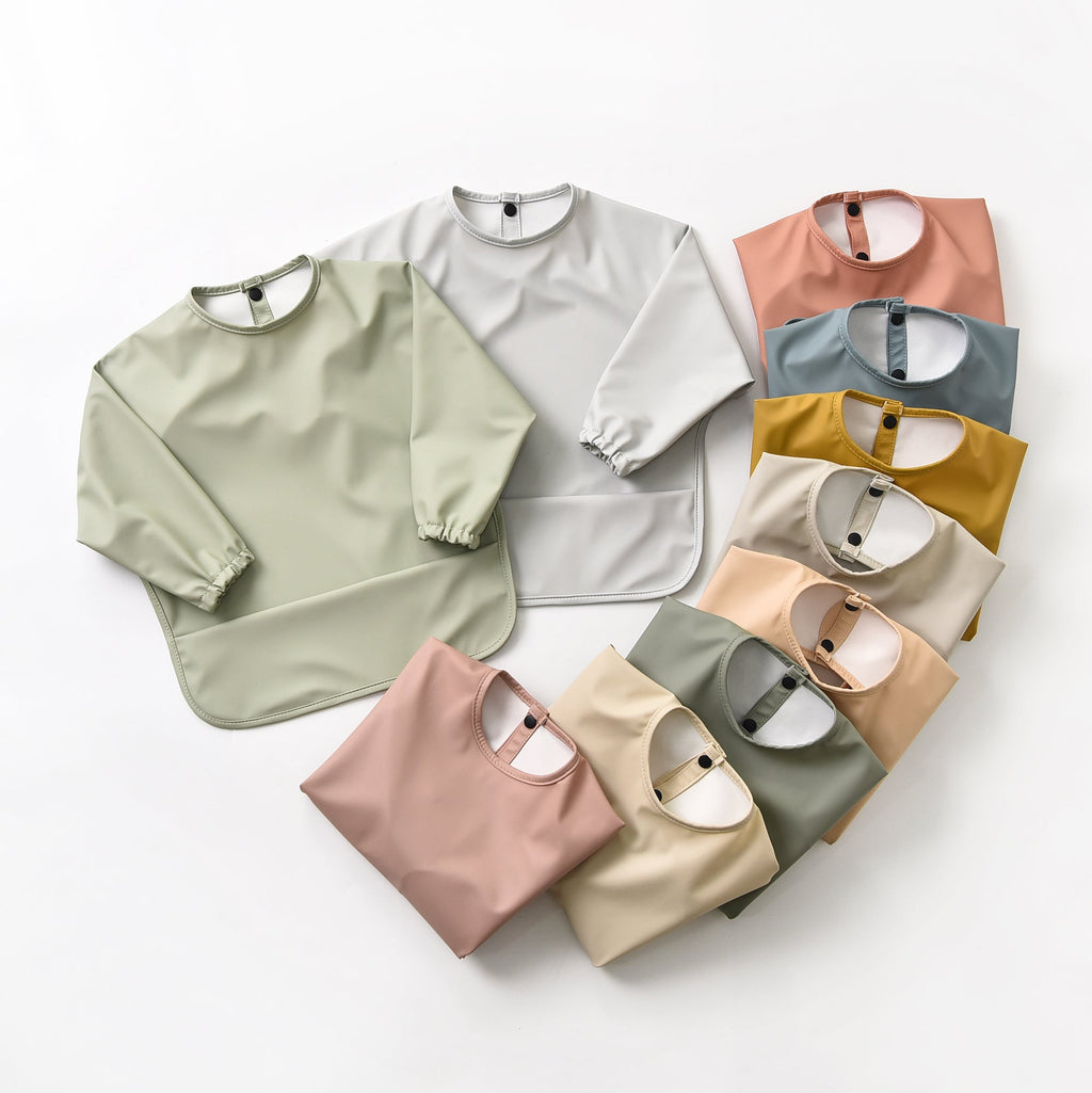 Baby wearing baby bib during mealtime — Green Smoke Waterproof Baby Smock Bib Long Sleeve