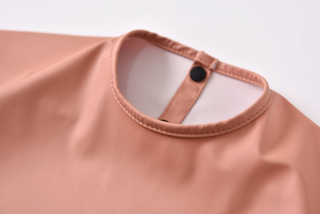 Green Smoke Waterproof Baby Smock Bib Long Sleeve — baby bib styled flat lay with nursery accessories
