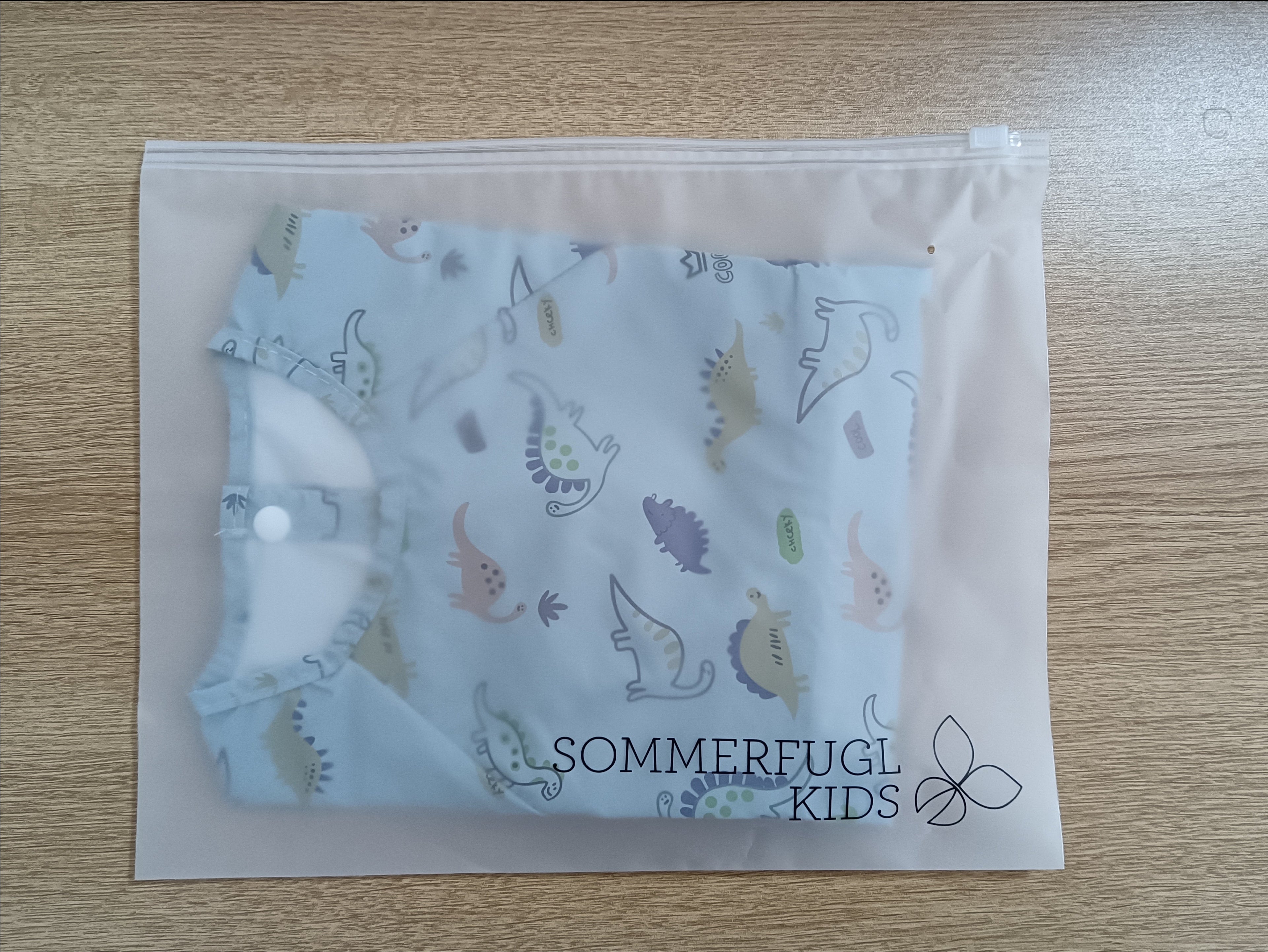 Jurassic Blue Waterproof Baby Smock Bib Long Sleeve — cat baby bib showing face and soft texture