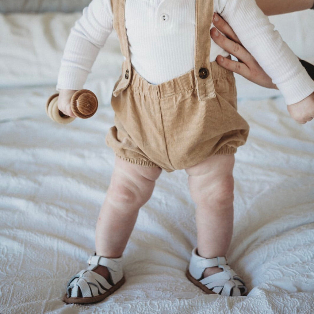 White Leather Baby Sandal — baby sandals styled flat lay with nursery accessories