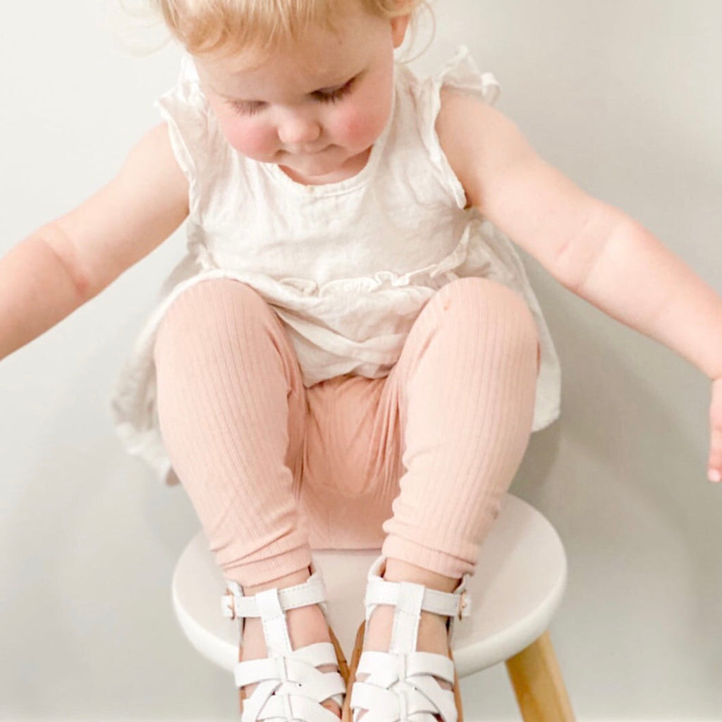 White Leather Baby Sandal — baby sandals styled flat lay with nursery accessories