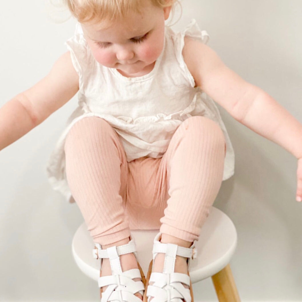 White Leather Baby Sandal — baby sandals styled flat lay with nursery accessories