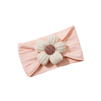 Chalk knitted flower on coral pink cable knit baby headband on white background