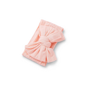 coral orange ribbed knit baby headband with re-tieable oversized double bow, designed for newborns and toddlers