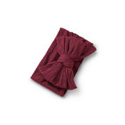 magenta red ribbed knit baby headband with re-tieable oversized double bow, designed for newborns and toddlers