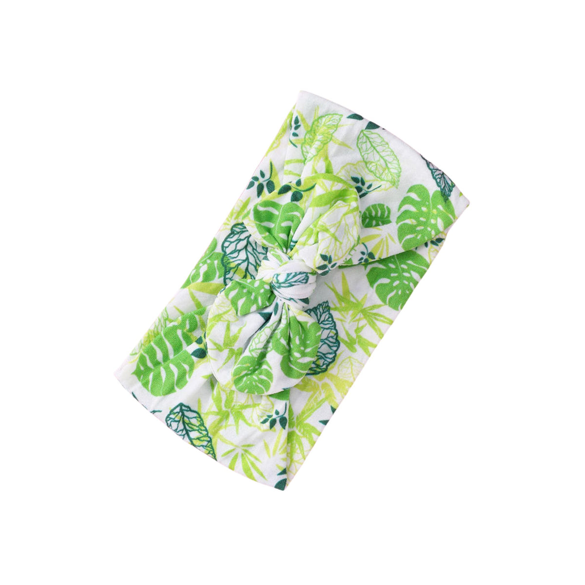 Jungle Leaves print nylon bow baby headband with bright green monstera, palm and fern leaves on white, knotted bow at front, Sommerfugl Kids