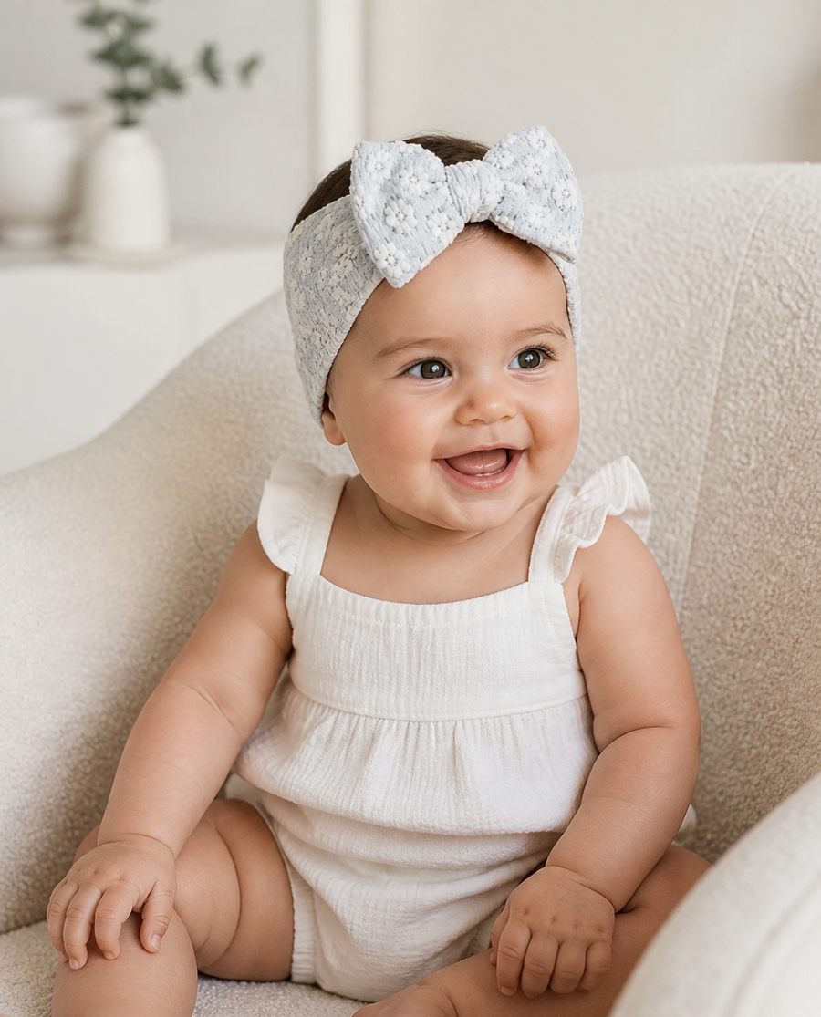 Baby in a powder blue lace bow headband