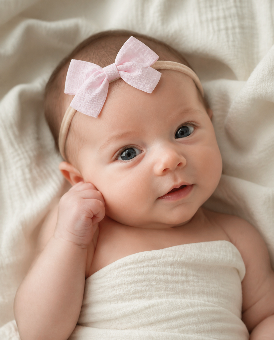 Newborn in a tiny bow headband