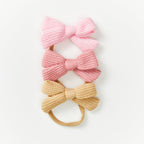 Baby Knitted Bow Headband in Fairy Floss — close-up of bow on fairy floss baby headband