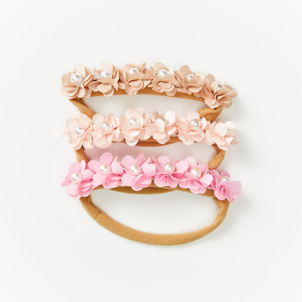 Delicate Baby Flower Crown with Pearls: Sunset Snow Flower Girl Headband — close-up of floral on baby headband