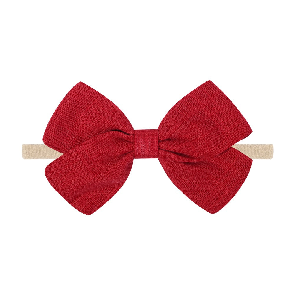 Tinka tiny bow baby headband in cherry