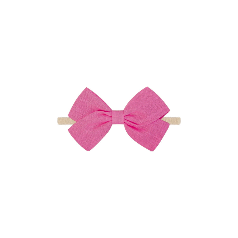 Tinka tiny bow baby headband in fuchsia