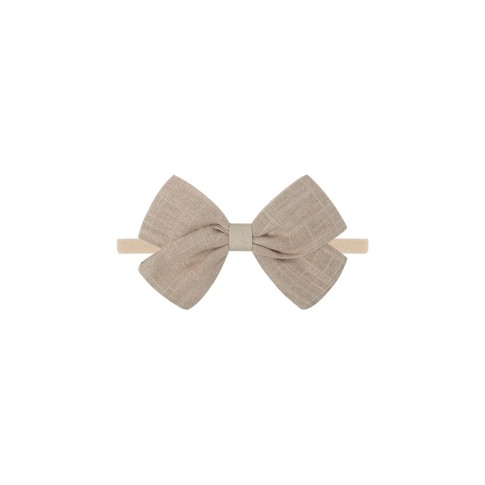 Tinka tiny bow baby headband in taupe