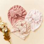 Newborn wearing navy baby turban with textured — Baby Girl Waffle Bow Turban